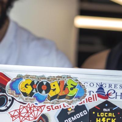 Two people looking at a laptop screen